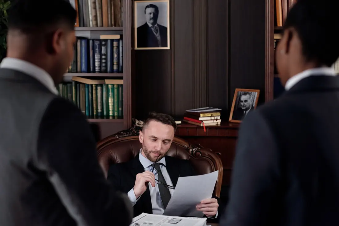 Lawyers reviewing a case file with a client